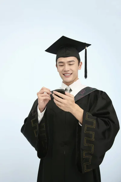 Man Mortarboard Graduation Gown Using Pda Phone — Stock Photo, Image