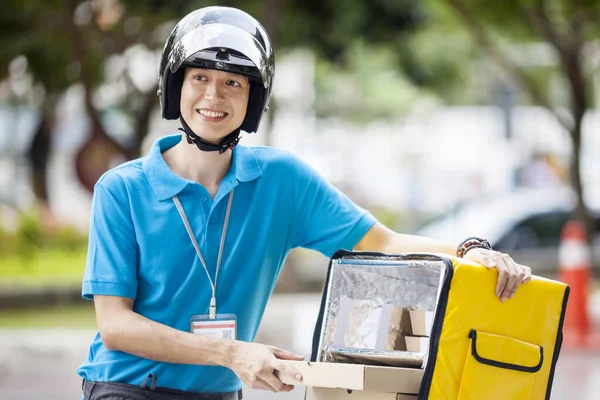 Food delivery man taking food from a bag