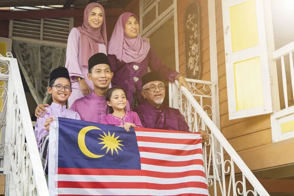 Muslim family with the Flag of Malaysia