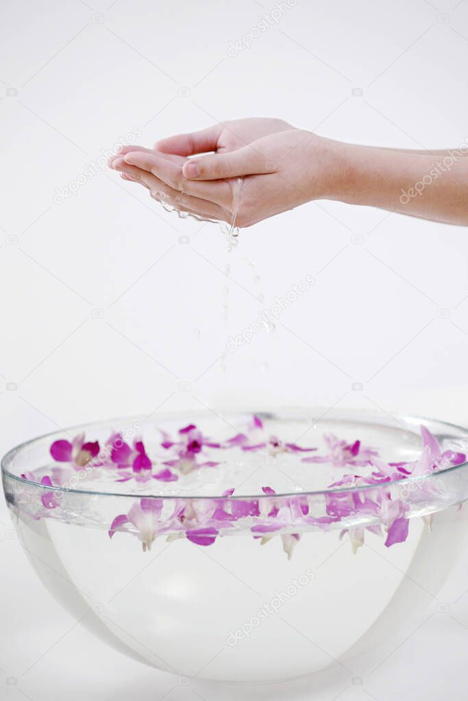 Hands cupping water from wash bowl