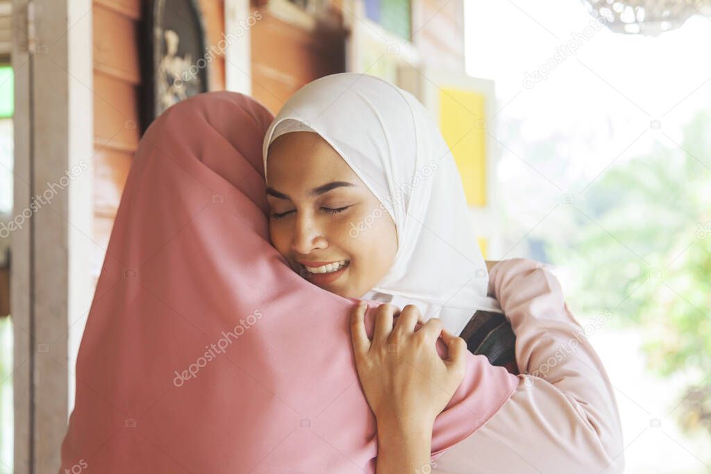 Mother hugs her daughter