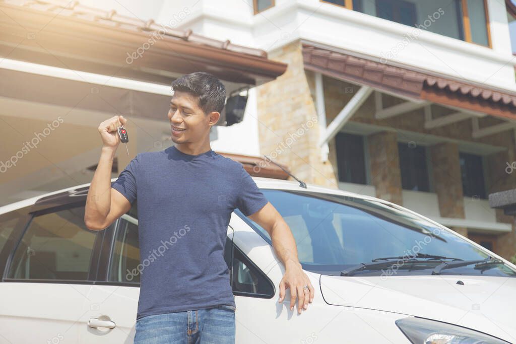 Mid adult man smiling at his car keys