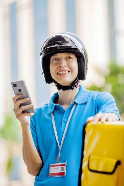 Food Delivery Man Έλεγχο Θέση Ένα Κινητό Τηλέφωνο — Φωτογραφία Αρχείου