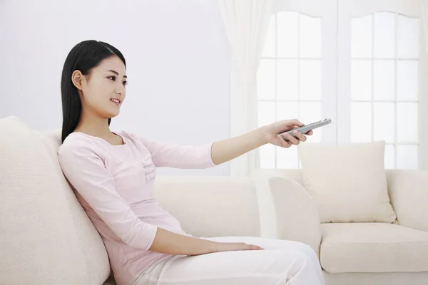 Woman Holding Remote Control — Stock Photo, Image