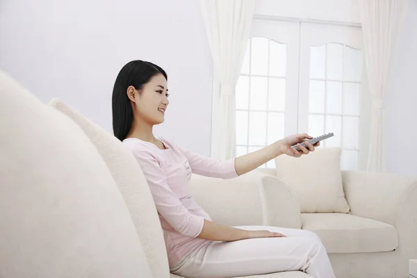 Woman Holding Remote Control — Stock Photo, Image