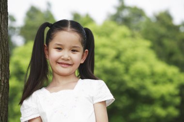 Kız kameraya gülümsüyor.