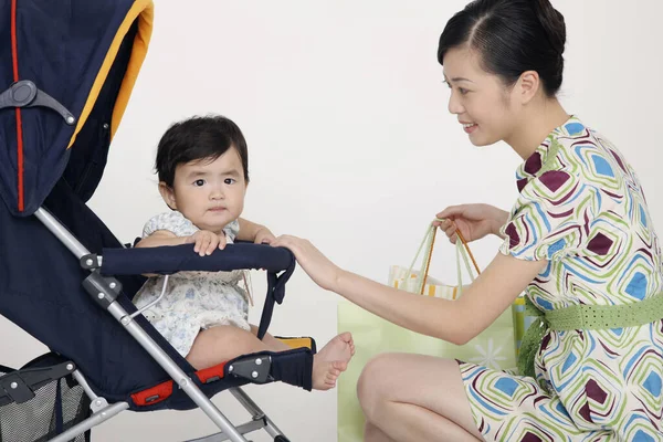 Woman Checking Baby Girl Stroller — Stock Photo, Image