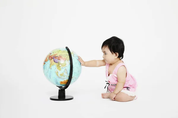 Baby Girl Touching Globe — Stock Photo, Image