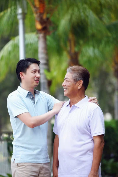 Man Giving His Father Pat Shoulder While Talking — Stock Photo, Image