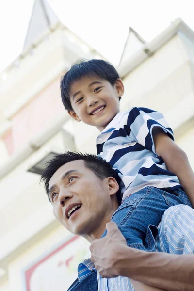 Father giving son a piggy back ride