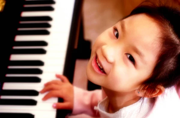 トップ角度ビューの若いです女の子遊びピアノ — ストック写真