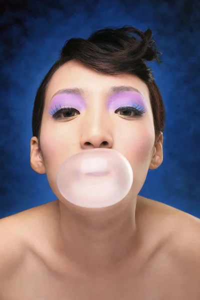 Woman blowing bubble gum