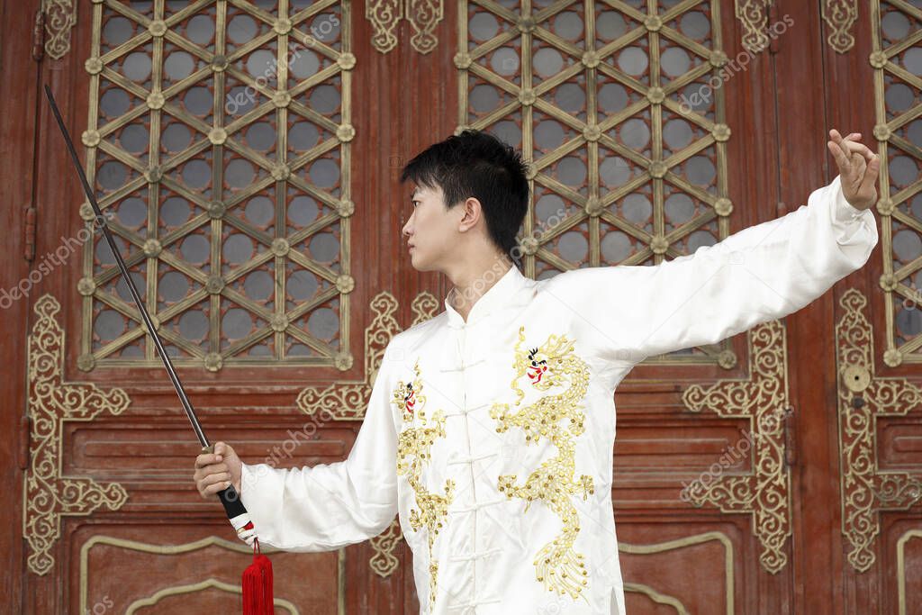 Man practising martial arts with a sword