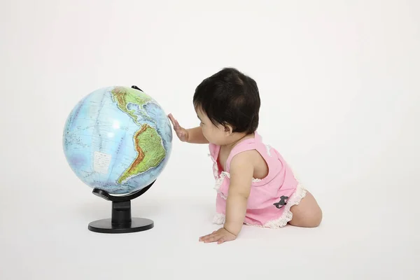 Baby Girl Touching Globe — Stock Photo, Image