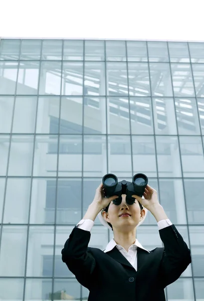 Portrait of Businesswoman using binoculars
