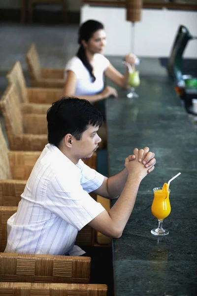 Man and woman at restaurant with their drinks