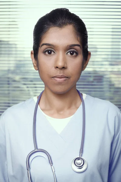 Woman with stethoscope looking at the camera