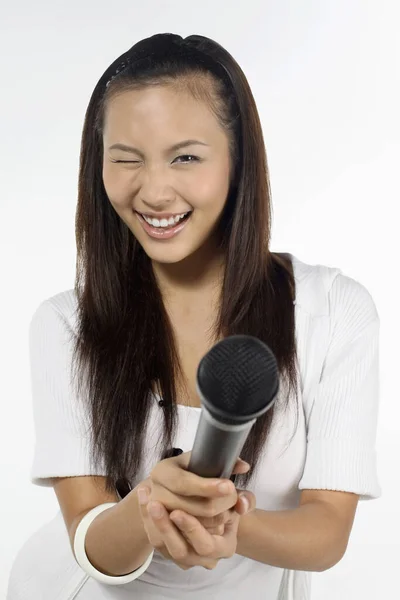 Mulher Piscando Olho Enquanto Segura Microfone — Fotografia de Stock