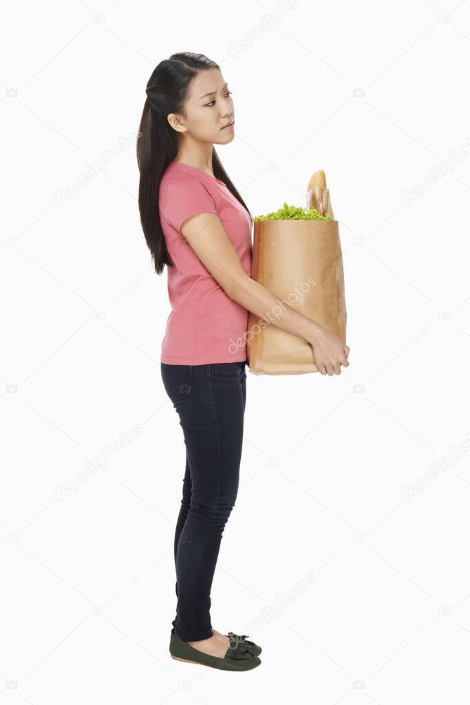 Woman carrying a bag of groceries