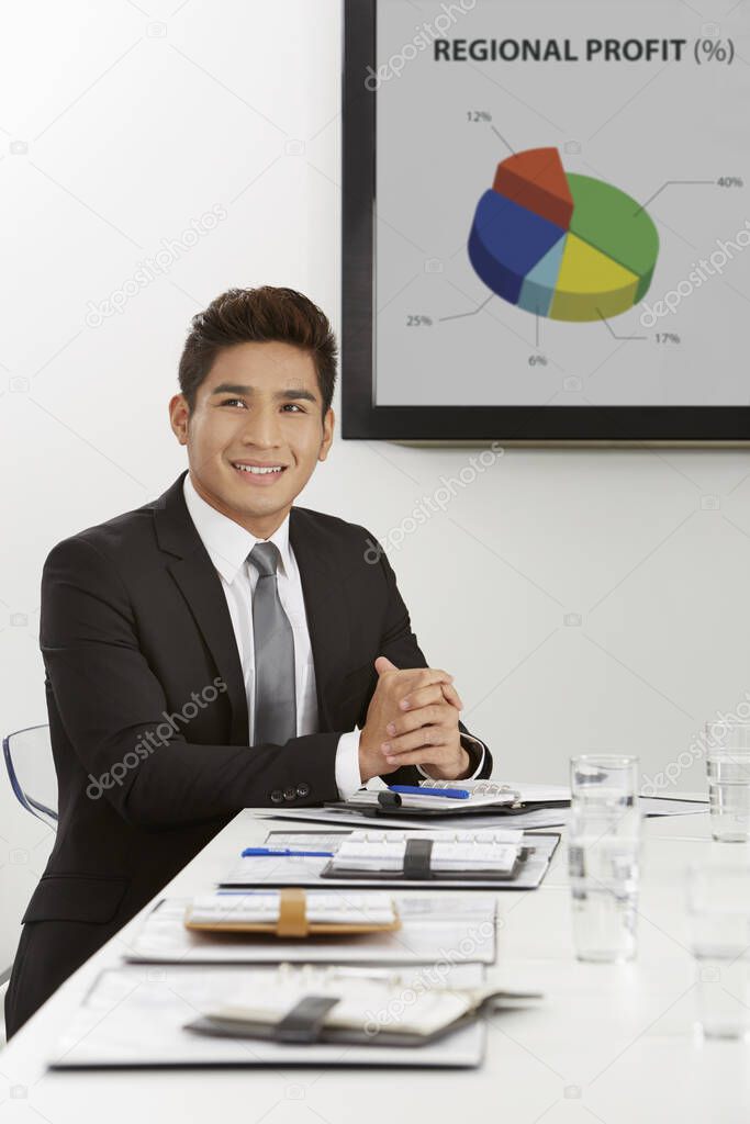 Cheerful businessman sitting in a meeting room