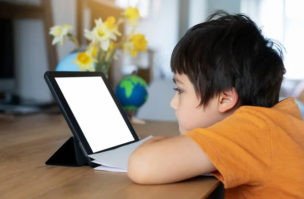 Kid stay at home watching cartoon on teblet, Child using digital tablet searching information on internet for his homework during covid-19 lock down,Social Distancing, learning online education