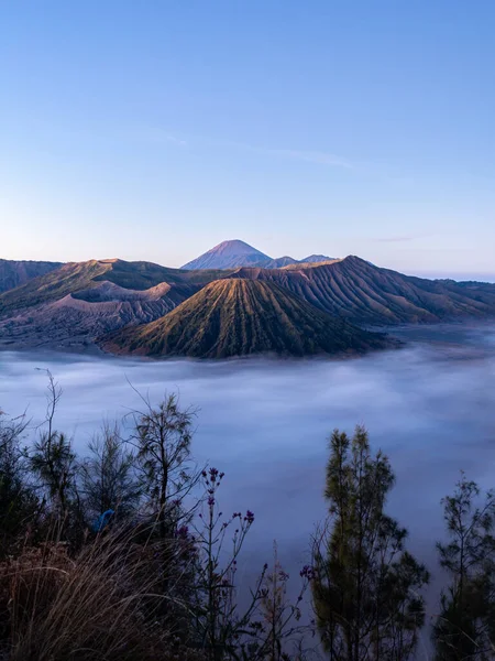 Mount Bromo, is an active volcano and part of the Tengger Mountains in a photograph during a sunny morning, in East Java, Indonesia