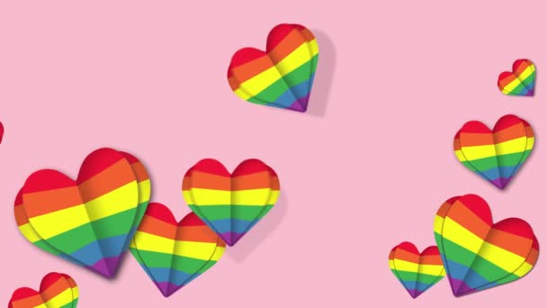 Muchos corazones de arco iris sobre fondo rosa. Flying hearts lgbt orgullo símbolo — Vídeo de stock