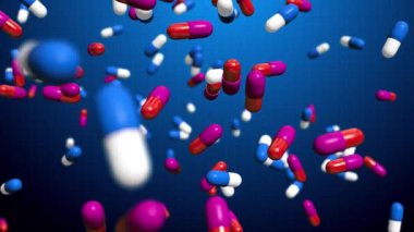 Mavi arka planda yavaş çekimde düşen çok renkli haplar. Tıp animasyonu.
