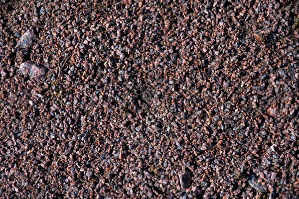 Granit parçacıkları ya da küçük granit molozları. Ezilmiş doğal taş. Ev ve parkların peyzaj tasarımı için kullanılıyor. Sert ve karıncalı bir doku.. 