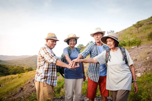 Asian Elderly Groups Travel, Trekking and Mountains They join hands together, happy life after retirement. Elder community concept