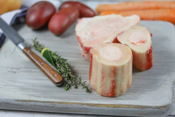 bone marrow and vegetables on a cutting board