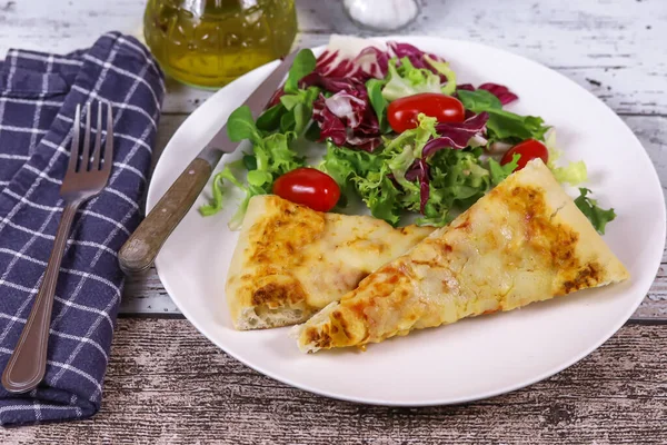 margarita pizza and salad on a plate