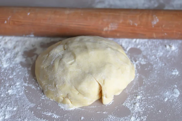 ball of dough and rolling pin