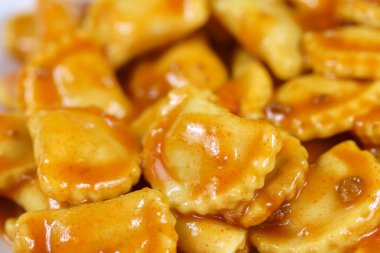 Ahşap bir masada domates soslu ravioli tabağı