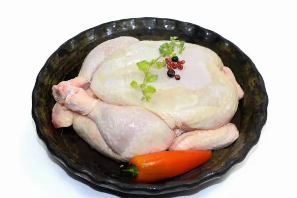 raw whole chicken on a white background