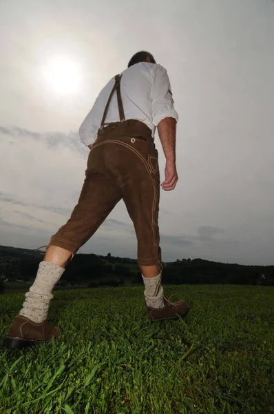 Man in traditional leather pants walking in the nature