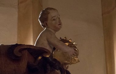 Angel or putto figure in a catholic church, sacred cherub clipart