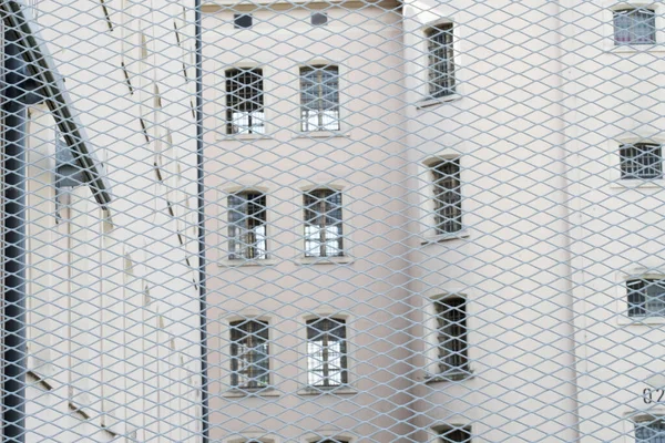 Prison from the outside with a fence, seeing prison windows