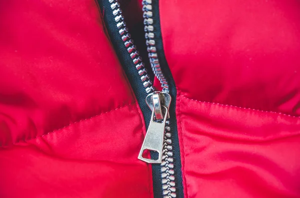Metallic zipper on a red women\'s jacket