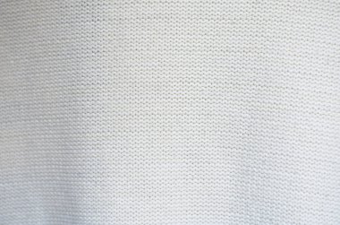 Kalıplı kazaklar kapanıyor. Beyaz ve gri örgü deseni pürüzsüz