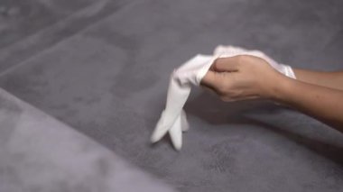 4k Asyalı erkek eli beyaz koruyucu eldiven giyiyor, bir elinde gri arka plan, kendini karantina, hastalığın yayılmasını önleme, virüs önleme, Corona virüsü 2019, COVID 19, sağlık sigortası 