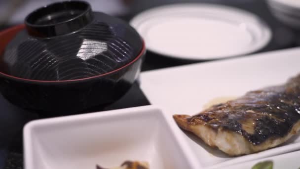 4K日本語ランチメニュー 閉じるグリルサバ魚 アジア料理 栄養食事 オメガ3 蛍光灯 味噌汁ボウル 緑野菜 食事コースディナー 品質成分 — ストック動画