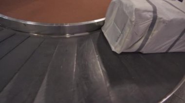 Terminaldeki Varış Salonunda hareket eden bir elektronik bagaj bandı, hava ulaşımının son durağı, yolcu ayrıcalıkları servisi, uluslararası seyahat, ait olunan dağıtımda personel yardımı