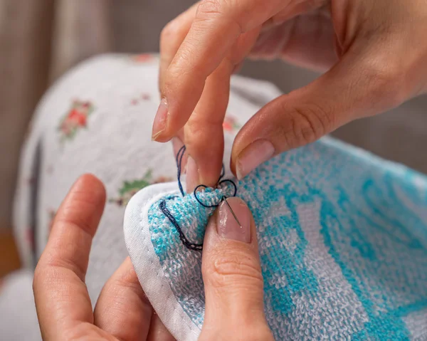 Needlewoman sews and mending clothes — 스톡 사진