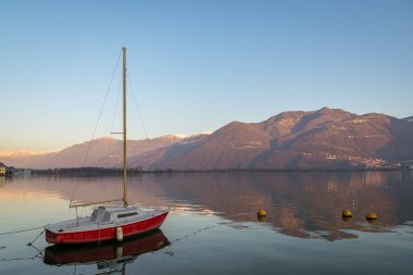 wonderful red boat on stunning mountain Iseo lake