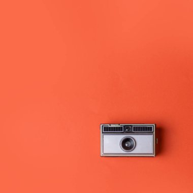 Turuncu bir arkaplanda eski model fotoğraf makinesi.