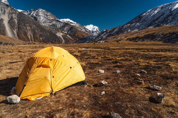 Yellow tent at Kongma Dingma campsite between Mera peak and Amphulapcha high pass, Himalaya mountains range in Nepal, Asia