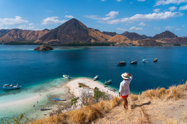A traveller standing on top of Kelor island in Flores island Komodo national park, Indonesia, Asia