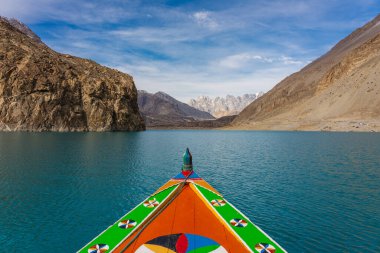 Colorfull boat in Attabad lake in Hunza valley, Karakoram montains range in Pakistan, Asia clipart