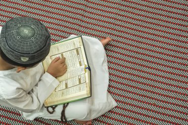 Al kuran oruç ayı boyunca (Ramazan) okuma çocuk. DOF ve kopya alanı.